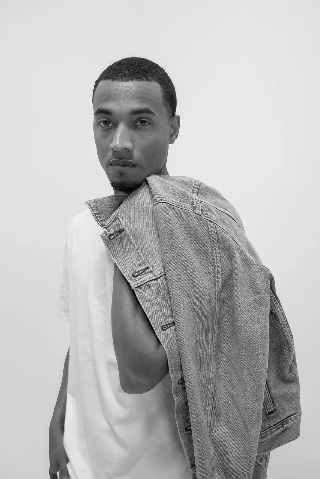 Vonté Smith — Black-and-white portrait with a denim jacket over the shoulder