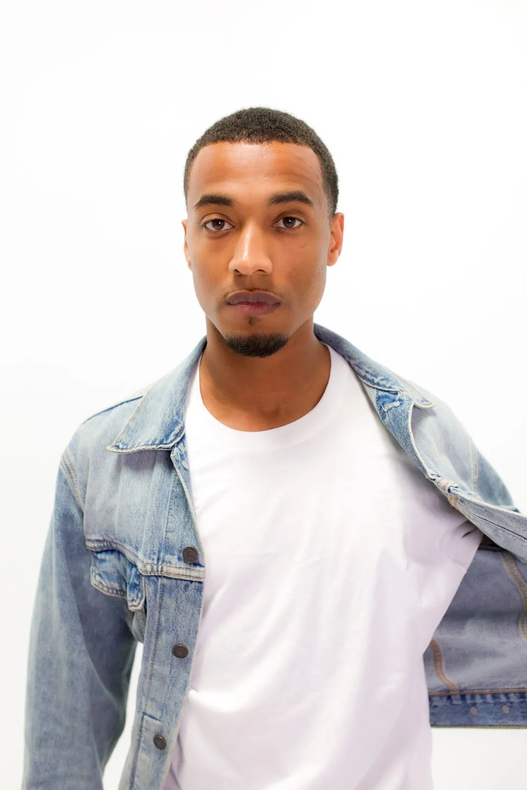 Vonté Smith — Denim jacket over a white tee, studio