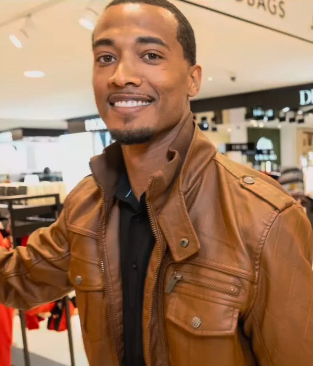 Vonté Smith — Smiling in a brown leather jacket in a retail store