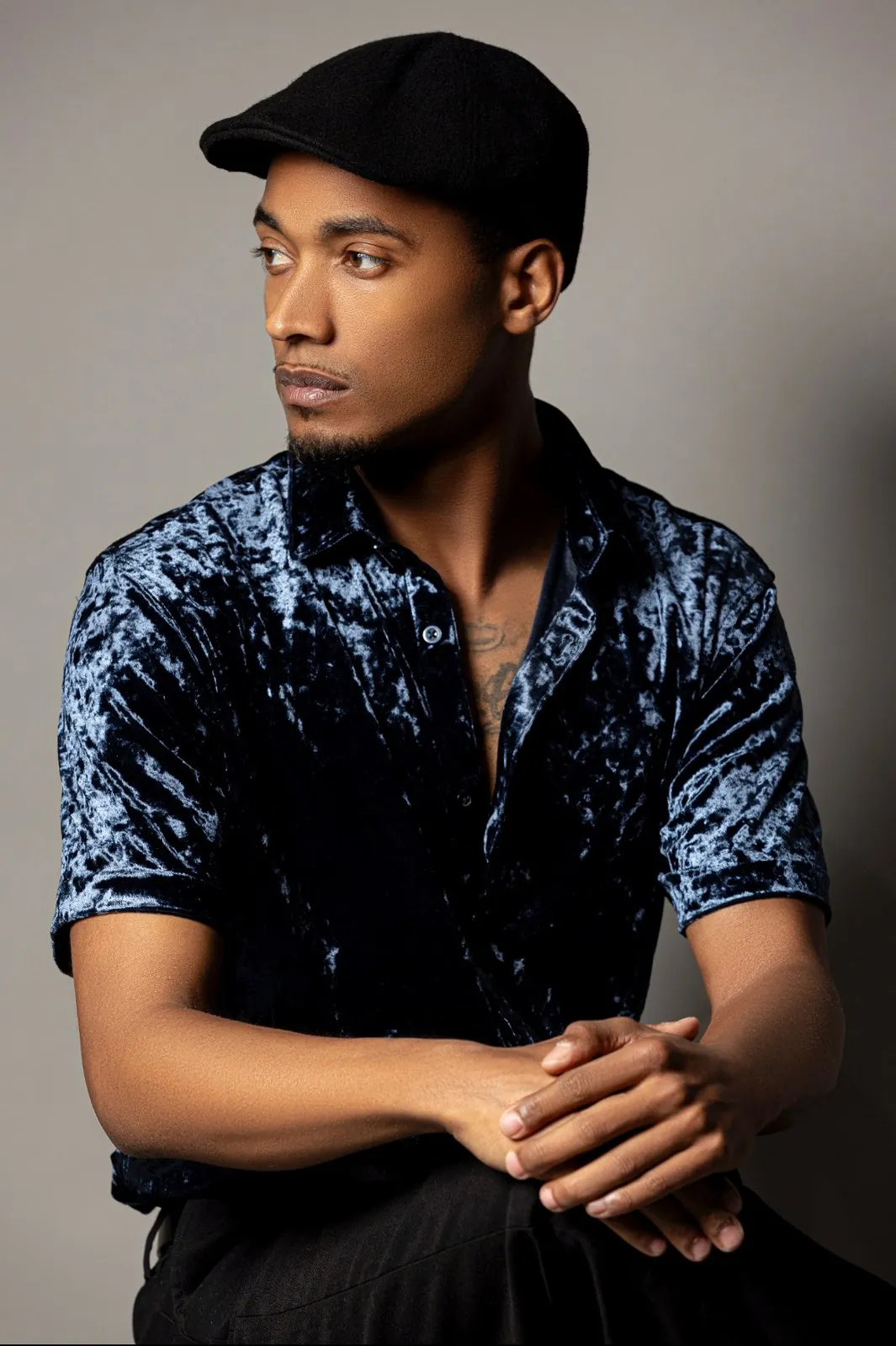 Vonté Smith — Velvet shirt and flat cap, studio portrait