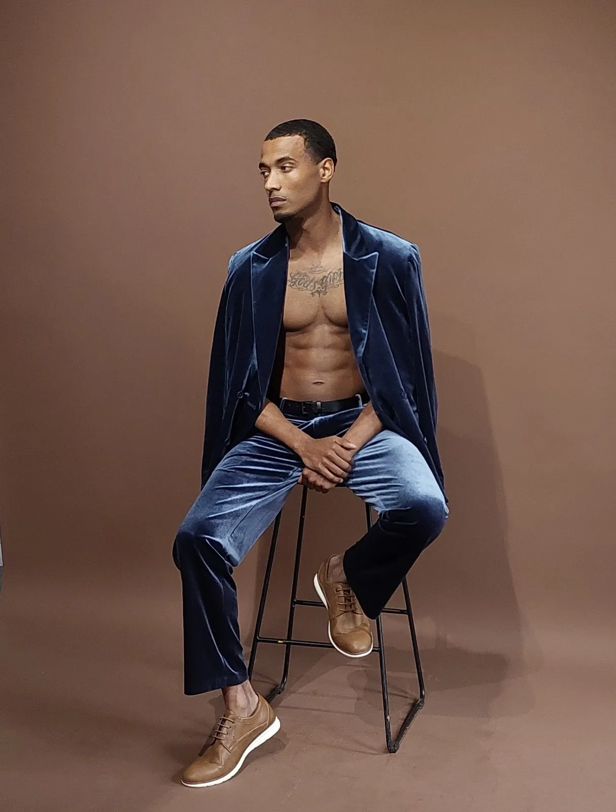 Vonté Smith — Navy velvet suit, seated on a stool